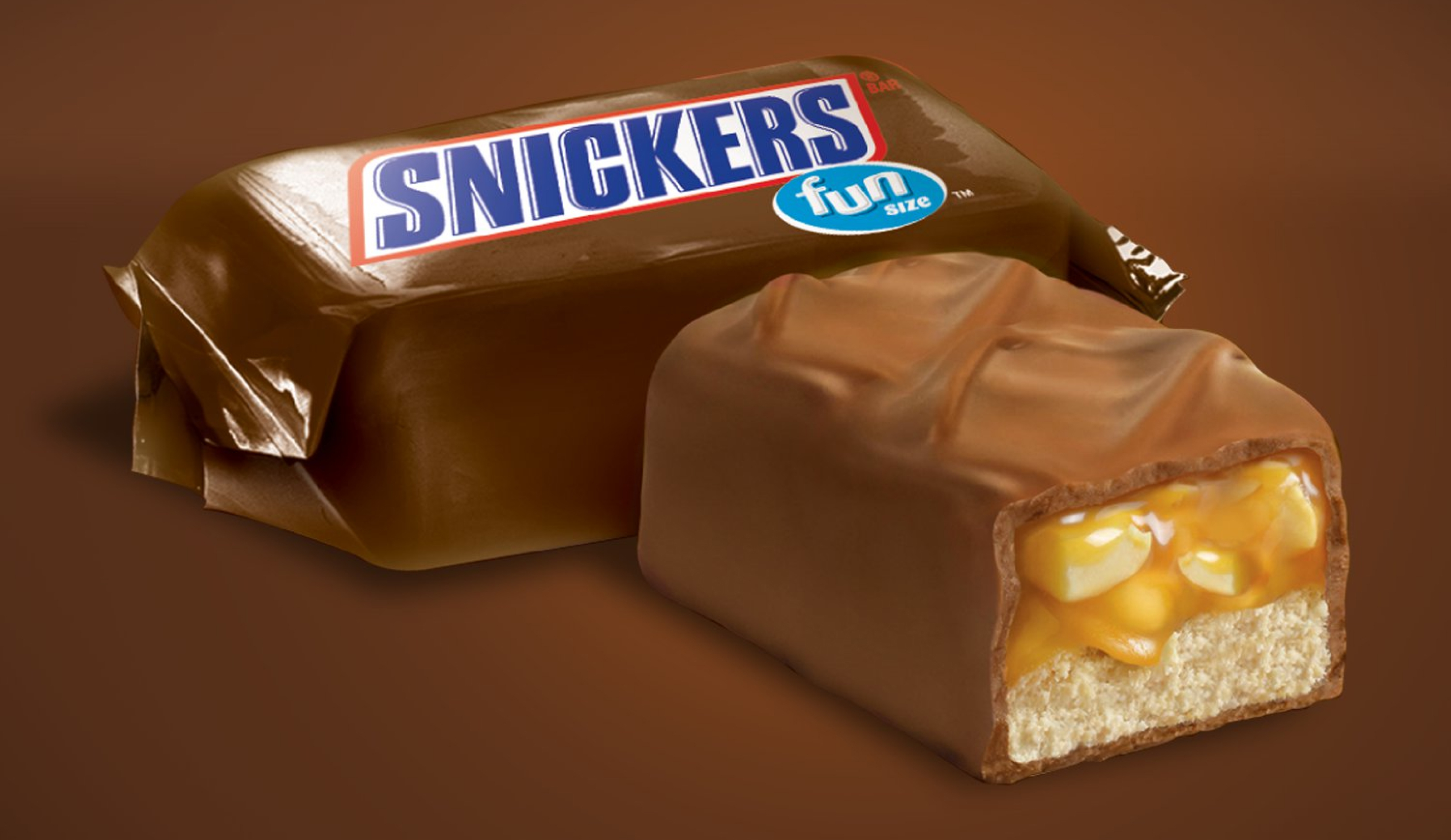 Cross-section of Snickers mini chocolate bar next to packaged mini bar