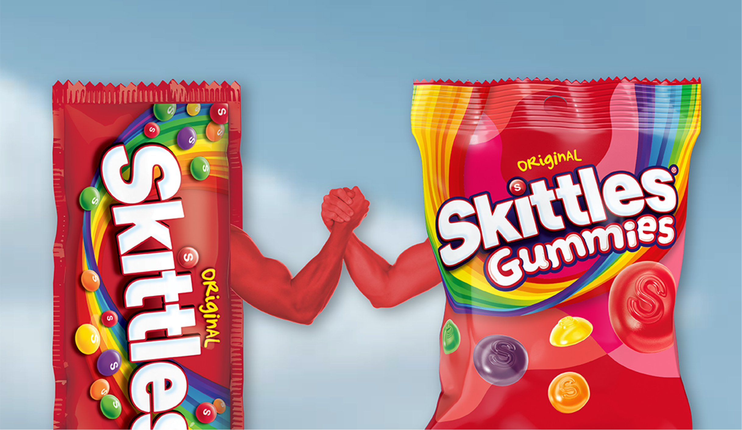 Skittles original chewy bag and skittles original gummies bag in an arm wrestling contest