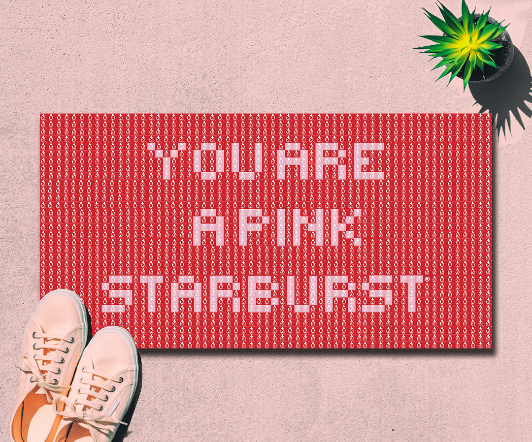 Floor mat of red and pink Starbursts with the words "You Are a Pink Starburst" spelled out