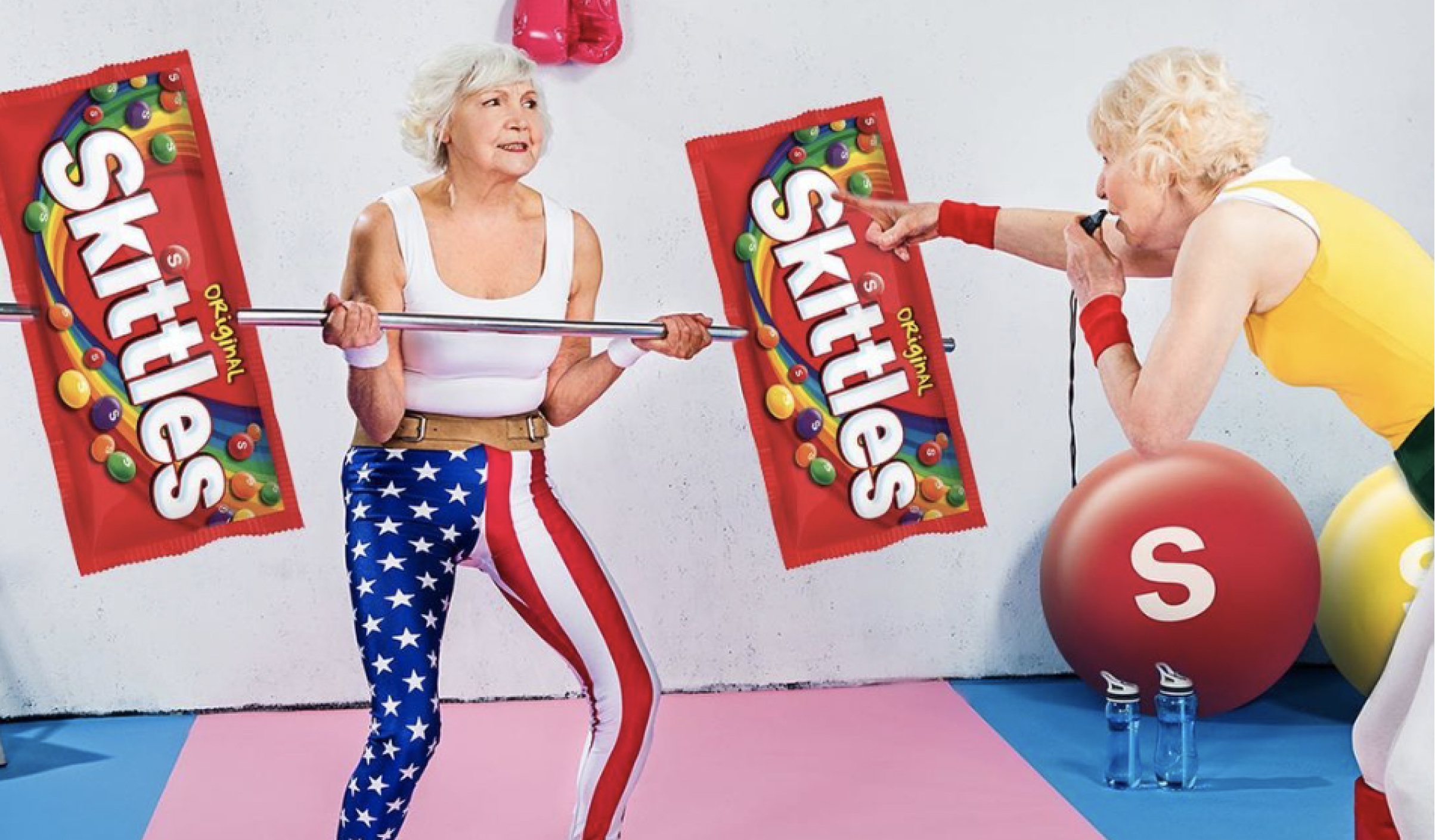 Elderly woman weightlifting with a bag of skittles originals
