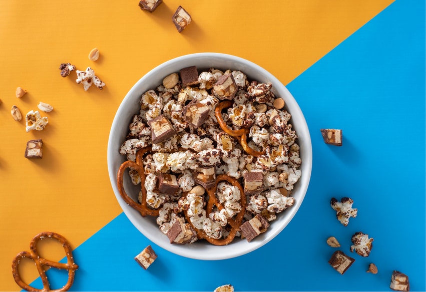 Bowl of sweet and salty snickers popcorn