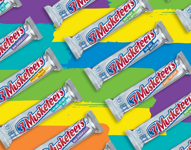 Five packaged 3 musketeers bars on colorful background