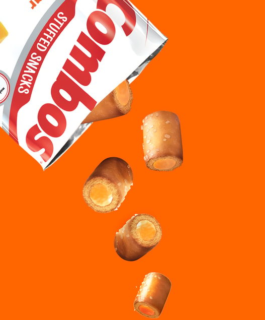 Close up of Cheddar Cheese Combos falling out of a bag on an orange background