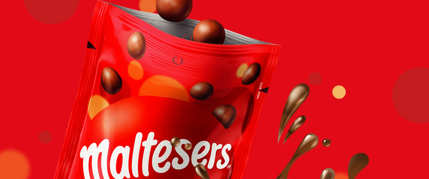 Open pouch of Maltesers with a Malteser falling into it on a red background