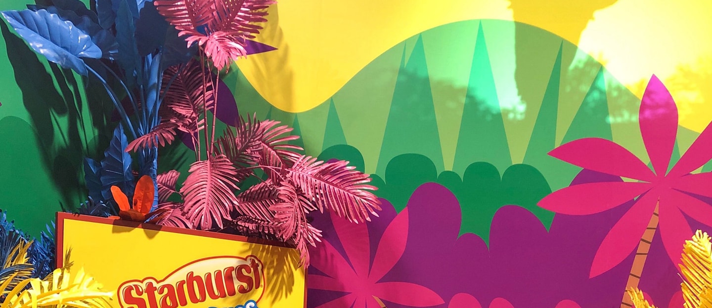 Jungle of bright colors and a yellow Starburst sign 