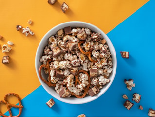 Bowl of sweet and salty snickers popcorn