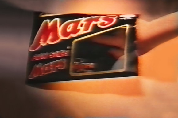 Mars Fun Size on gold background with hand